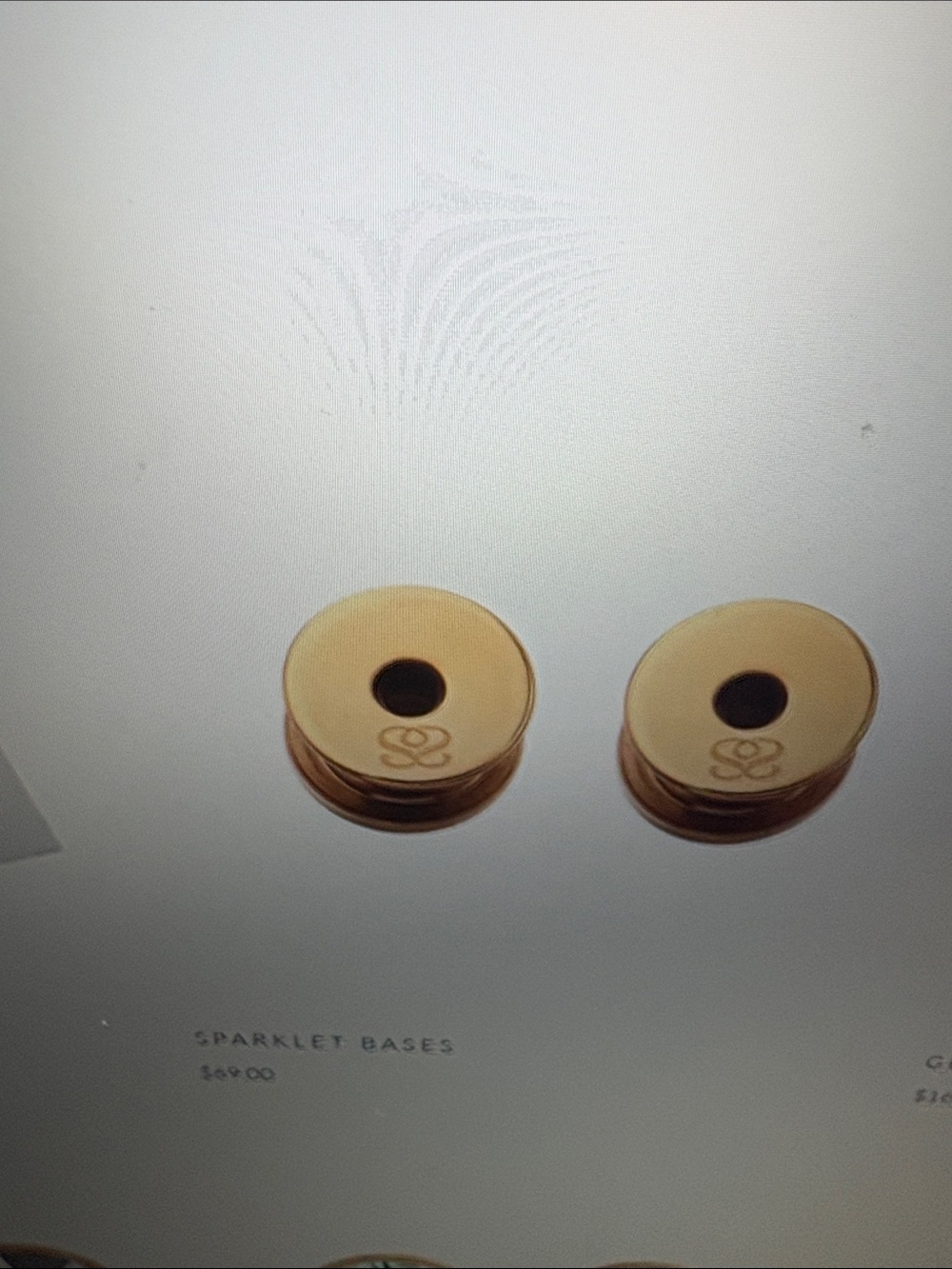 Two Gold Round Spark*l adapter bases for sparklets